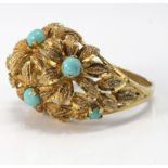 Yellow metal tested as 15-18ct yellow gold bomb shaped ring with floral decoration and turquoise.