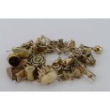 9ct charm bracelet with a good selection of charms attached. Approx weight 72.7g
