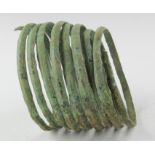 Viking coiled bracelet, ca. 900 - 1100 AD. Solid cast body with decorative patterns; terminals