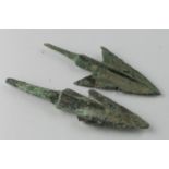 Pair of Bronze Age Arrow Heads, C. 1200 - 800 B.C. Cast bronze rhombic barbed arrowheads with