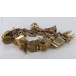 9ct charm bracelet with a good selection of charms attached. Approx weight 92.1g