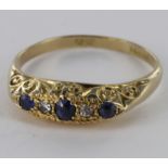 18ct sapphire and diamond graduated carved head ring, size P, weight 2.5g.