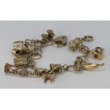 9ct charm bracelet with heart padlock clasp and twelve charms, weight 32.1g.