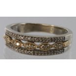 18ct two colour gold triple band ring with all three bands diamond set. Size Q, weight 4.1g.