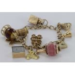 9ct Charm bracelet with a selection of charms attached. total weight 40.4g