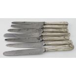 Six Georgian silver handled table knives with engraved armorials and worn hallmarks (one has a