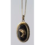 18ct oval onyx pendant with Egyptian head decoration, on long 18ct box chain. Weight 9.4g.