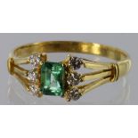 22ct yellow gold ring with centre rectangular emerald flanked on either side by three round