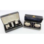 Boxed silver salts (2) with two silver-plated spoons and a boxed silver cruet set, comprising