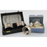 Five silver napkin rings (four boxed). There is only one matching pair, various hallmarks. Weighs