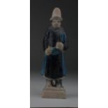 Ming Attendant Figure, C. 1368 - 1644 A.D. Ming attendant figure holding squezebox(?). Blue and