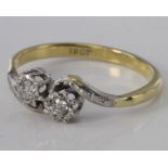 18ct diamond two stone crossover ring, size O, weight 2.6g.