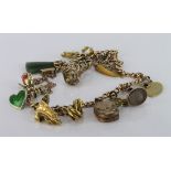 9ct charm bracelet with a variety of charms attached. Total weight approx 24.7g