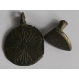 Mediaeval heraldic pendant, circular and with a loop at top, large flower like decoration, once