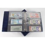 Collection of "Elizabeth II" notes in a blue album, includes E.C.T, Canada, Bahamas, Fiji, Gibraltar