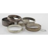 Six silver bangles, includes one small unmarked silver example - various dates and hallmarks. weight