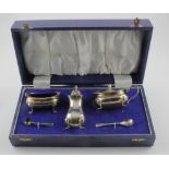 Silver three piece condiment set, hallmarked 'BESCo, Birmingham 1973', with two matching silver