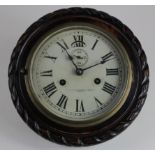 Brass ships bulkhead clock in carved mahogany mount, dial reads 'Wilson Fletcher Bruce & Sons Ltd,