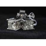 Pair of Platinum Solitaire Square cut Diamond Earrings approx 0.50ct Diamond weight. Weight 1.9g