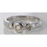 18ct white gold diamond three stone ring in rub over setting, size M, weight 4.2g.