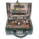 Thirteen piece silver hallmarked travelling vanity set, contained in a contemporary green leather