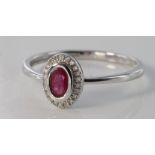 9ct white gold ruby and diamond oval ring, size N, weight 1.3g.