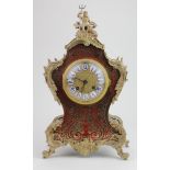 Ornate tortoiseshell and brass mounted mantle clock, with gilt finial depicting 'Poseidon', circa