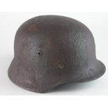 German Helmet an M35 model with sand / camo finish, minor interior surface corrosion, with liner,