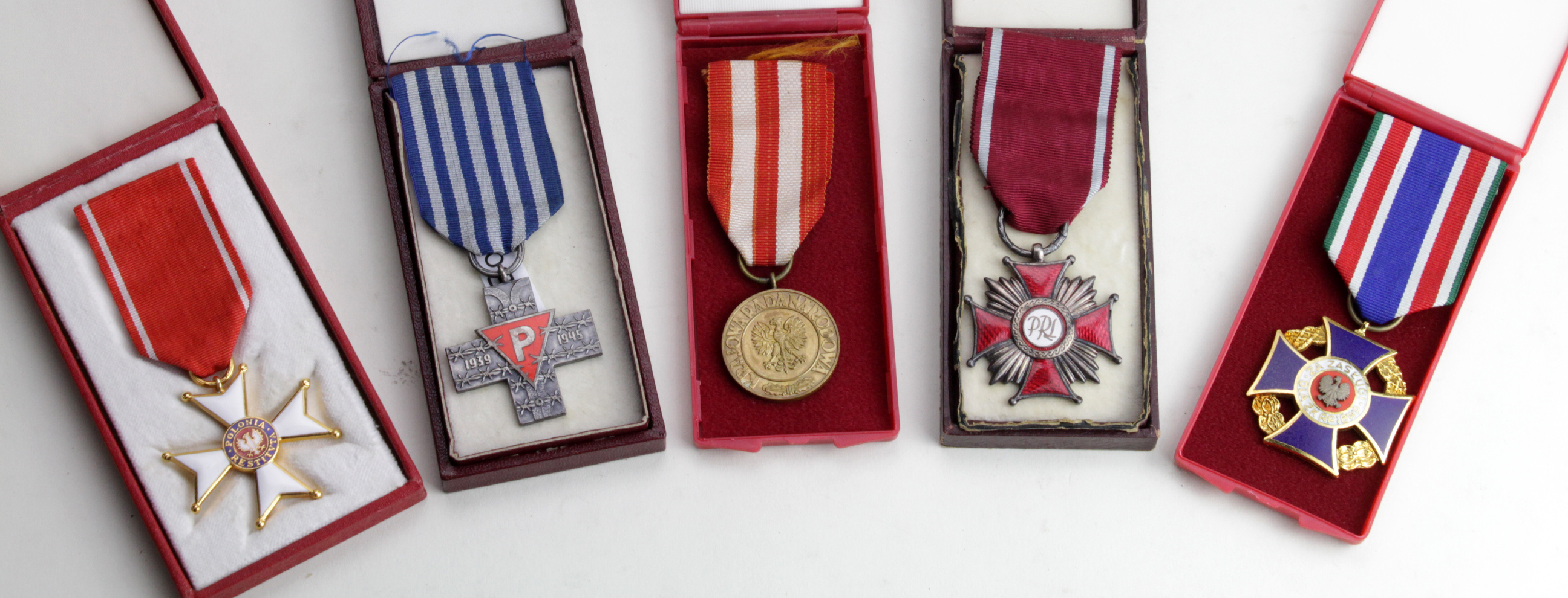 Poland cased medals - Auschwitz Cross, Cross of Merit Silver Clasp, Medal of Victory and Freedom