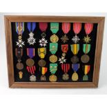 Belgium - collection of various full sized medals in glazed frame, some with ribbon emblems (21
