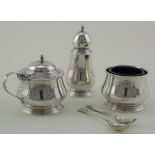 Three piece silver cruet with two silver spoons. All items are hallmarked. The salt, pepper &