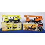 Dinky Toys 980 Coles Hydra Truck 150T, two examples, first orange/black, second yellow/black, in