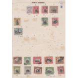 Stamps, North Borneo, early selection of 30+ stamps hinge mounted on 2 vintage album pages,