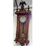 Vienna two-train walll clock with walnut case surmounted by an outstretched eagle, height 55in