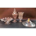Four pieces of antique glass to include a pedestal jar and cover with folded foot, a food cover,