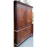 George III mahogany linen press, the moulded cornice over a pair of cupboard doors enclosing one