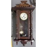 Vienna two-train mantel clock within stained case with architectural arch surmount, height 34in