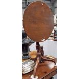 George III mahogany tripod table with a circular tilt top over a baluster turned pedestal and on