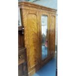 Victorian satinwood wardrobe, the ogee moulded cornice over three cupboard doors, one mirrored,