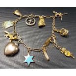 9ct gold charm bracelet with seven 9ct gold charms and other yellow metal charms, weight overall