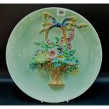 Clarice Cliff Newport Pottery relief moulded circular wall plate, moulded with a basket of flowers