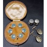 Pair of yellow metal faced and black enamel cuff links; together with a cased set of gold plated and