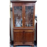 19th Century mahogany veneered bookcase with astragal glazed doors over a pair of cupboard doors,