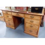 Victorian mahogany twin pedestal desk with writing inset over an arrangement of nine drawers,