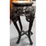 Chinese hardwood stand, the circular top with marble inset, the base with foliate carved and pierced