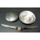 Silver pin dish with armorial, together with a silver toilet jar lid and a silver comb handle,