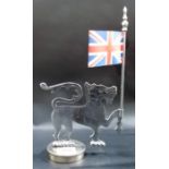 A chrome car mascot in the form of the Welsh Dragon holding a flag, height overall 9.75in.