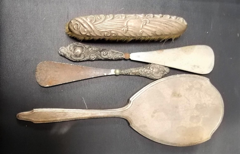 Four filled silver dressing table wares including an engine turned hand mirror (4).