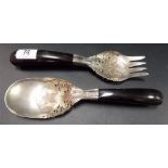 Pair of Malaysian white metal pierced and engraved salad servers with ebony pistol handles.