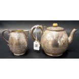 19th Century Indian silver ovoid foliate scroll engraved ovoid bachelor teapot and matching milk jug